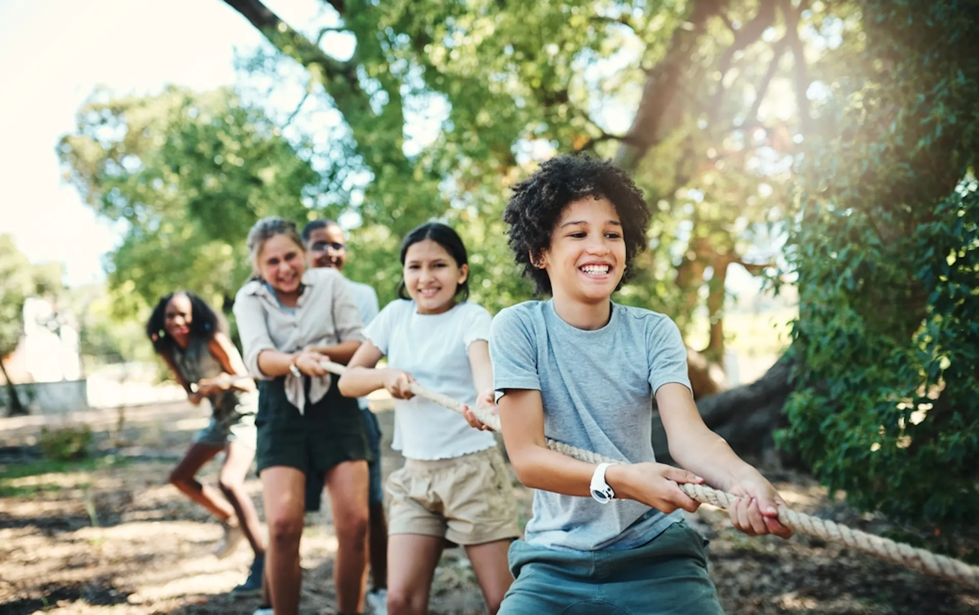 Group of kids at playing tug at a summer camp