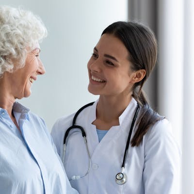 Elder patient with physician talking