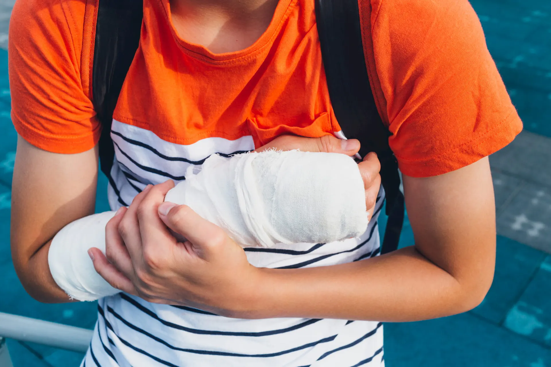 Boy holding arm with cast