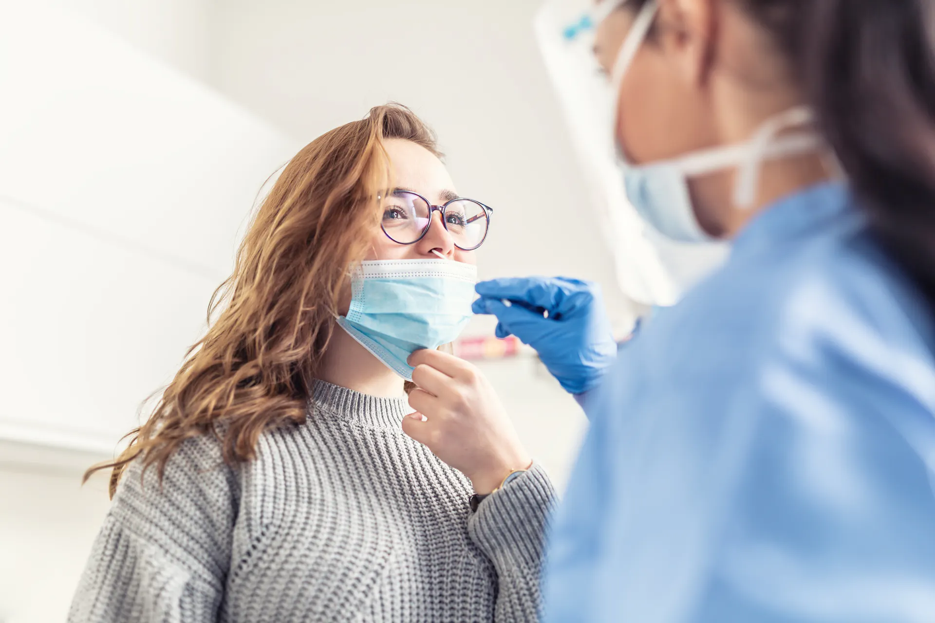 Provider testing a patient for COVID-19 with a nasal swab