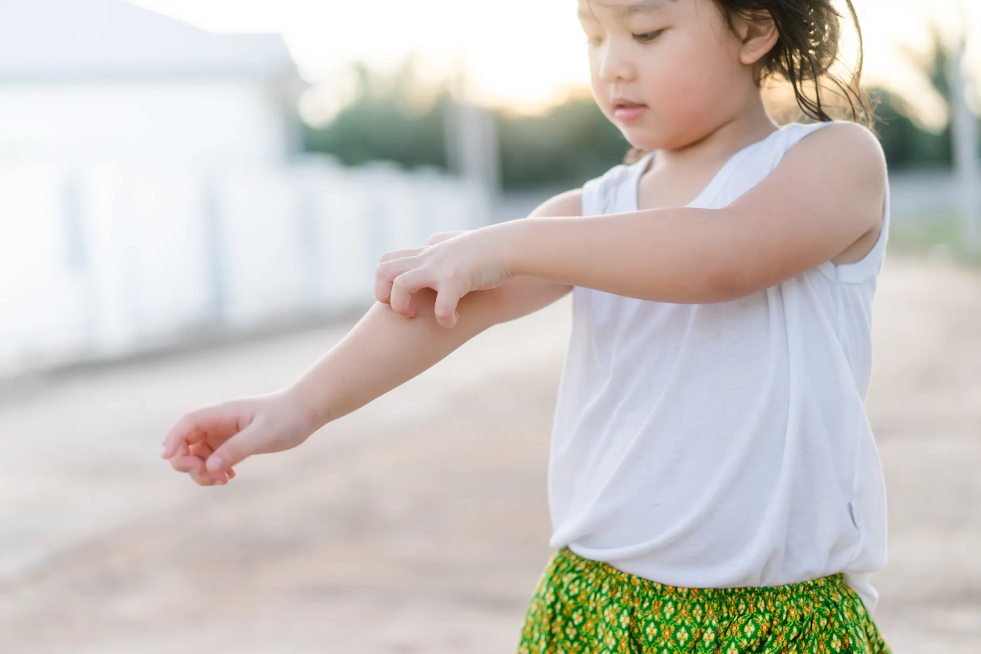 Young girl itching her arm