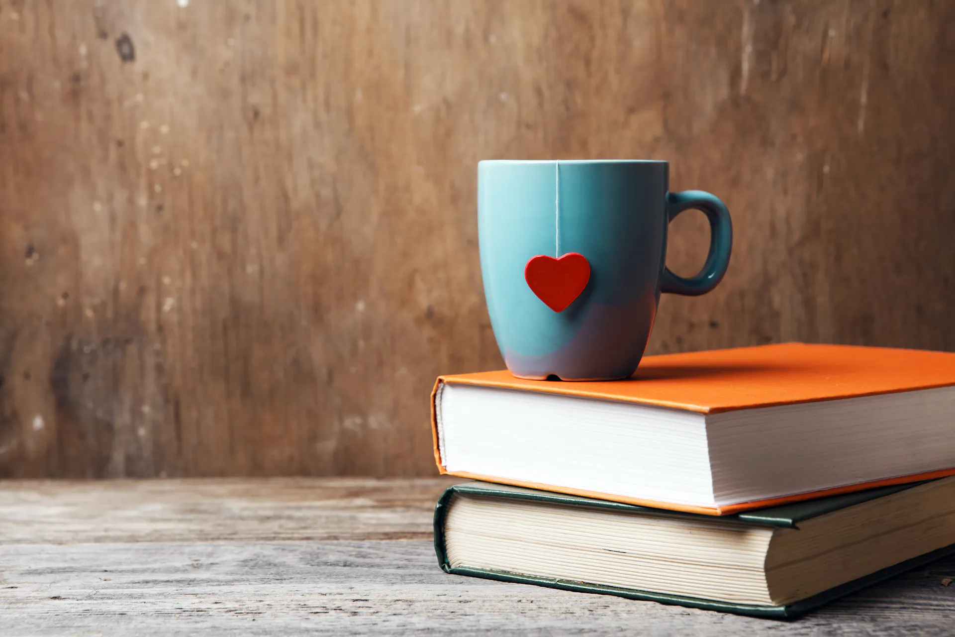A teacup sitting on top of two books