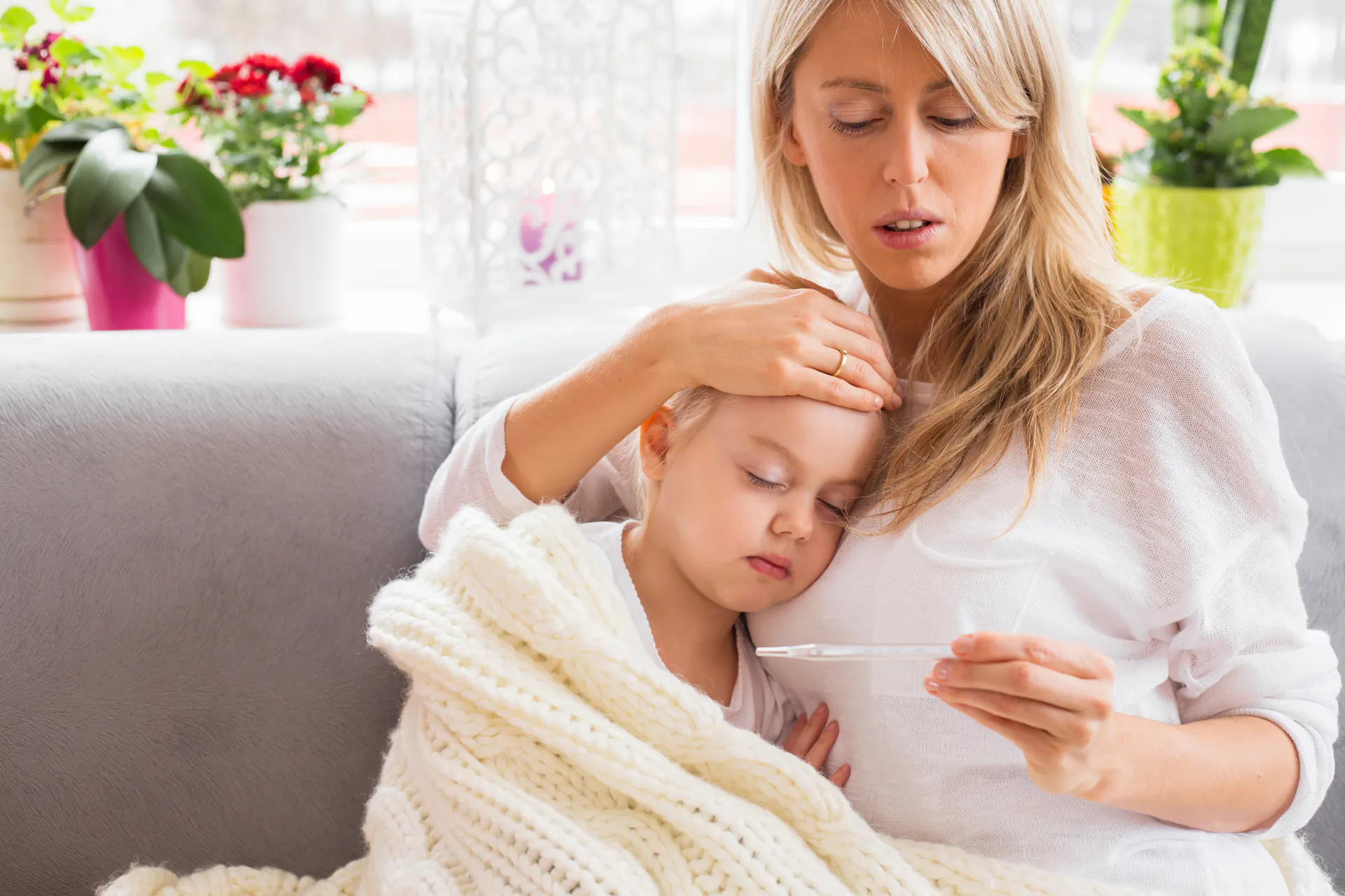 Mother checking the temperature of young child