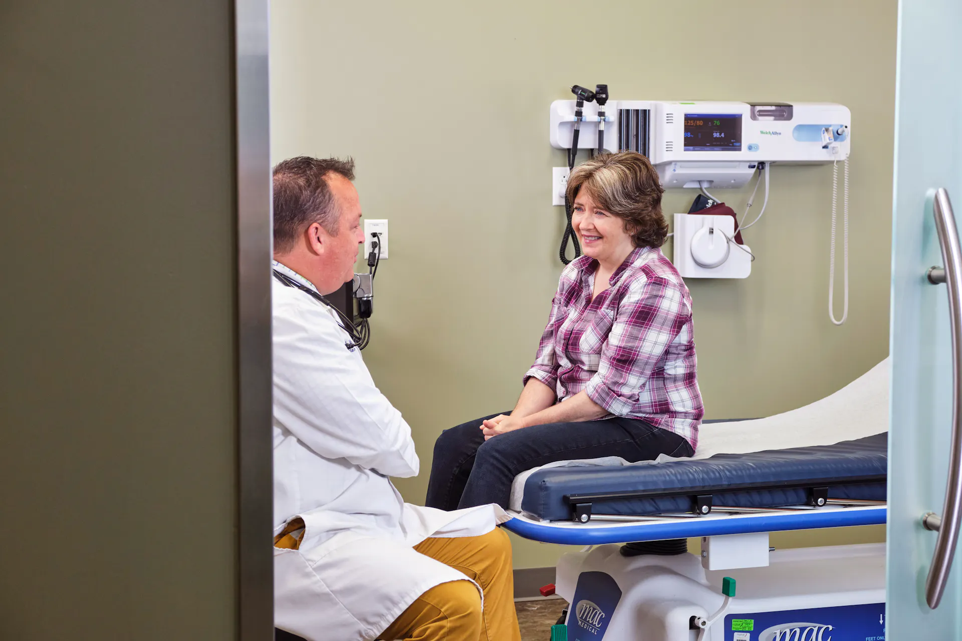 Middle-age woman speaking to a physician