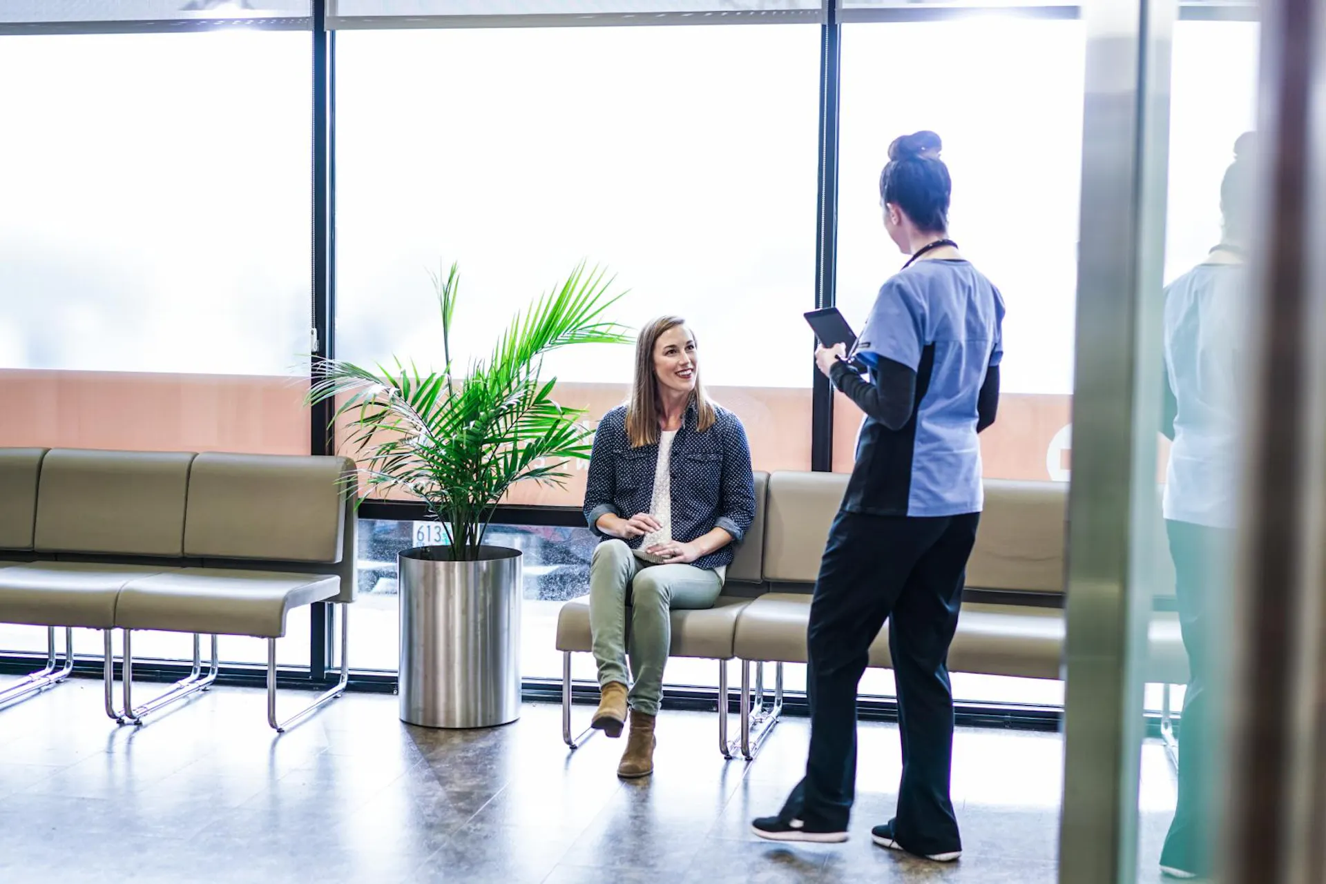 Female patient talking to provider in lobby