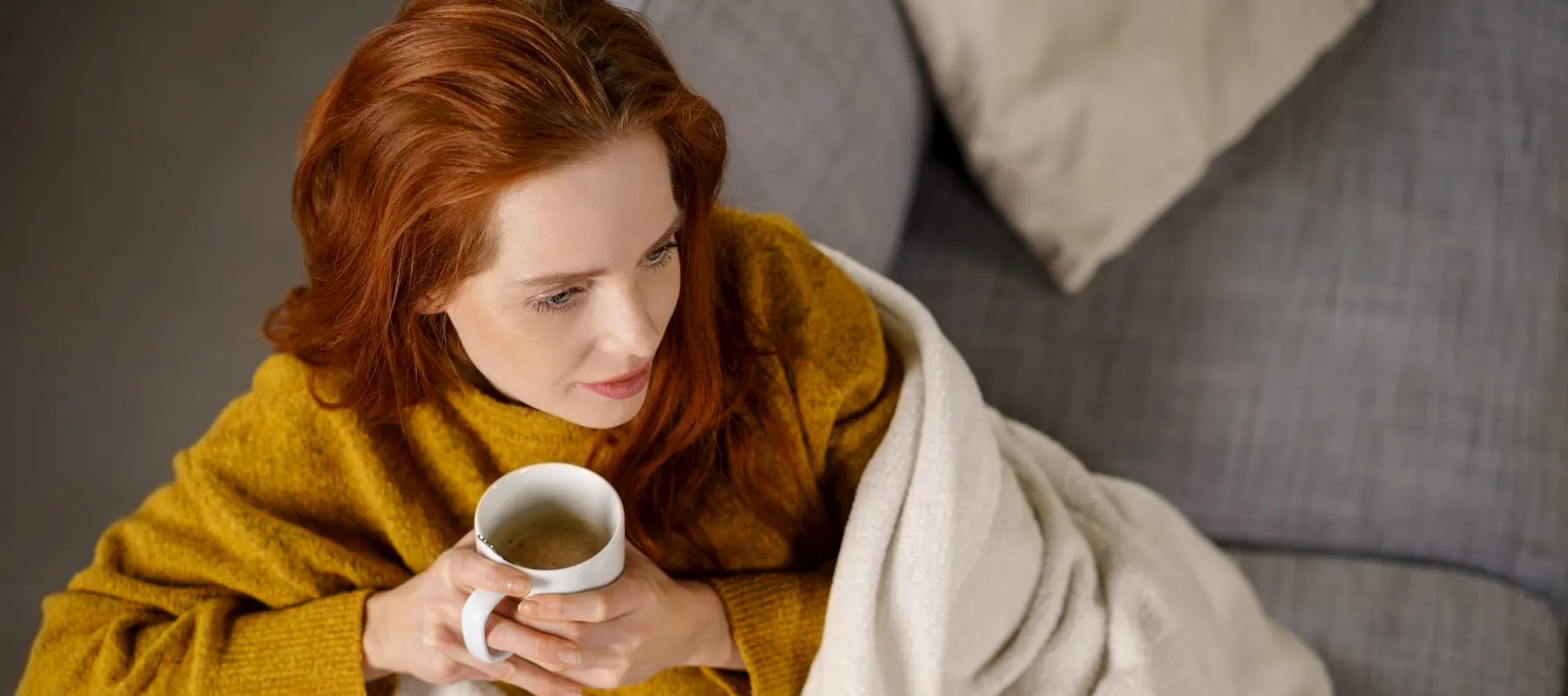 A women drinking a cup of coffee