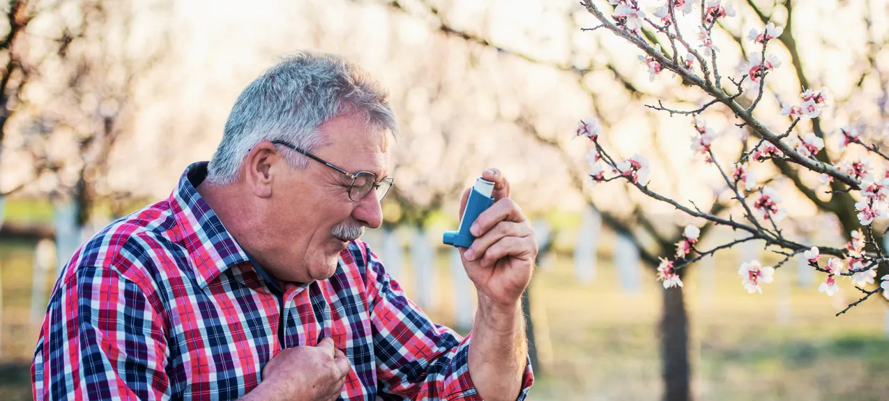 A man using his inhaler