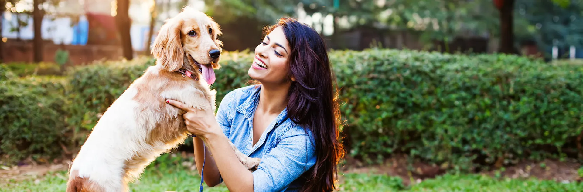 A girl playing with her pet dog
