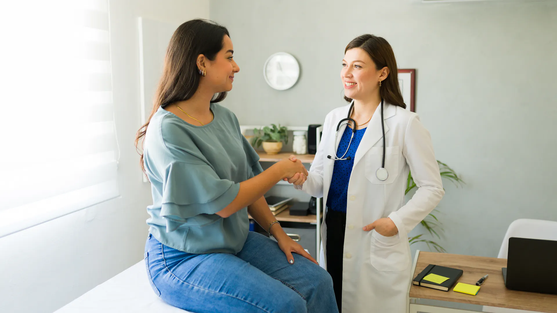 Woman shaking hands with patient