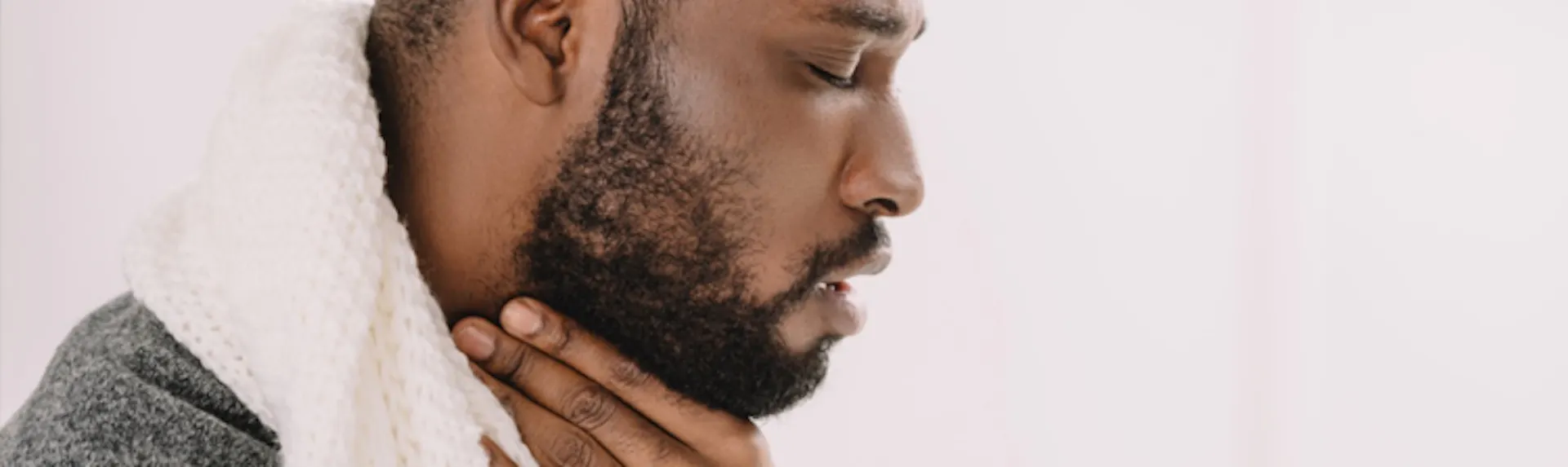 A man clutching his neck 