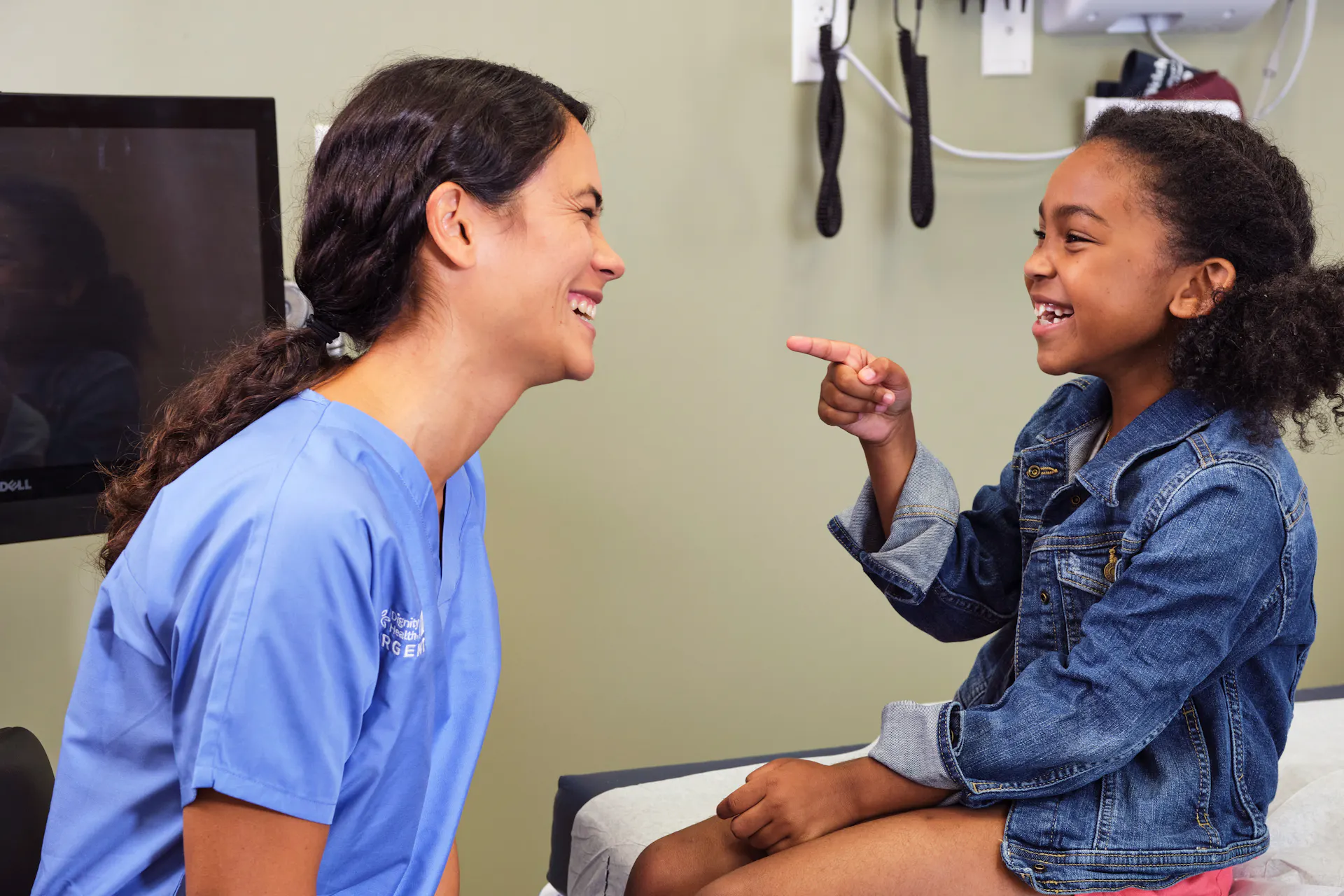 Provider and a young girl laughing together