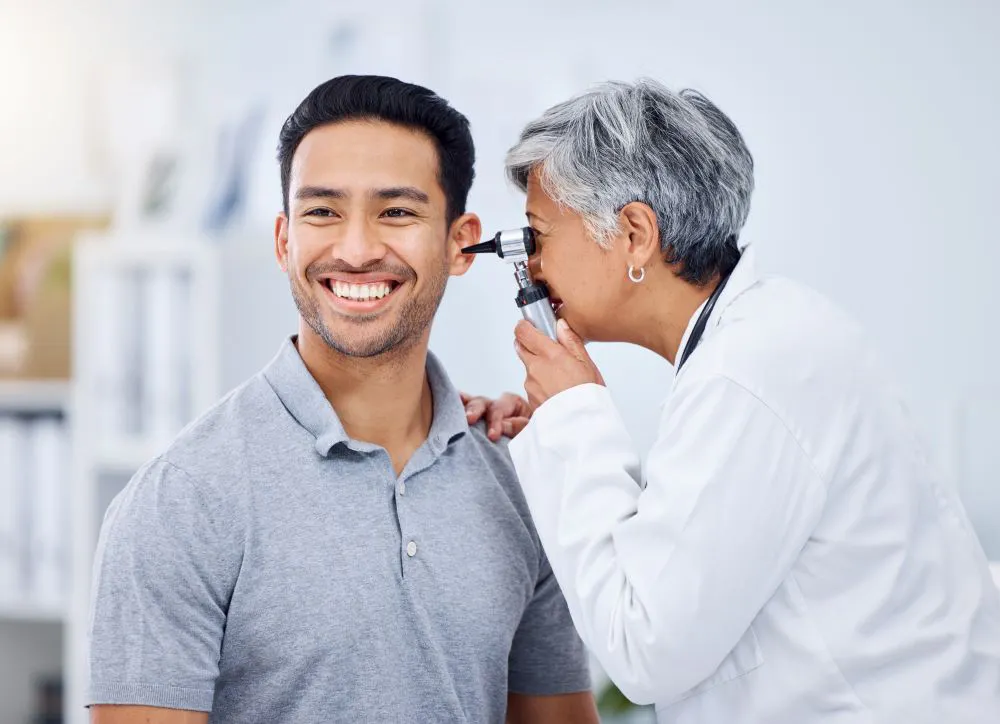 Ear check for healthcare or wellness at hospital with otolaryngology specialist.