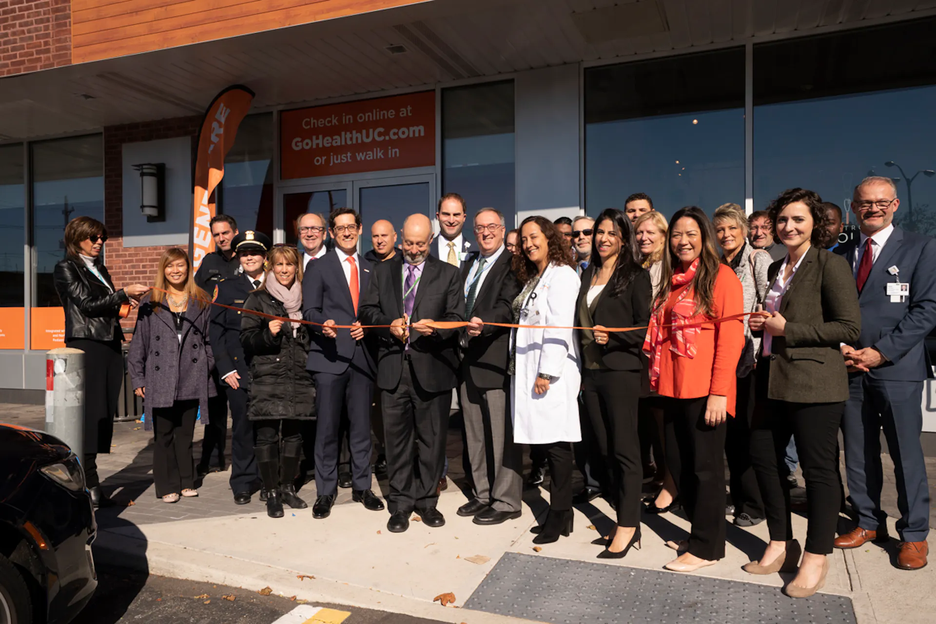 Ribbon cutting center image with team members