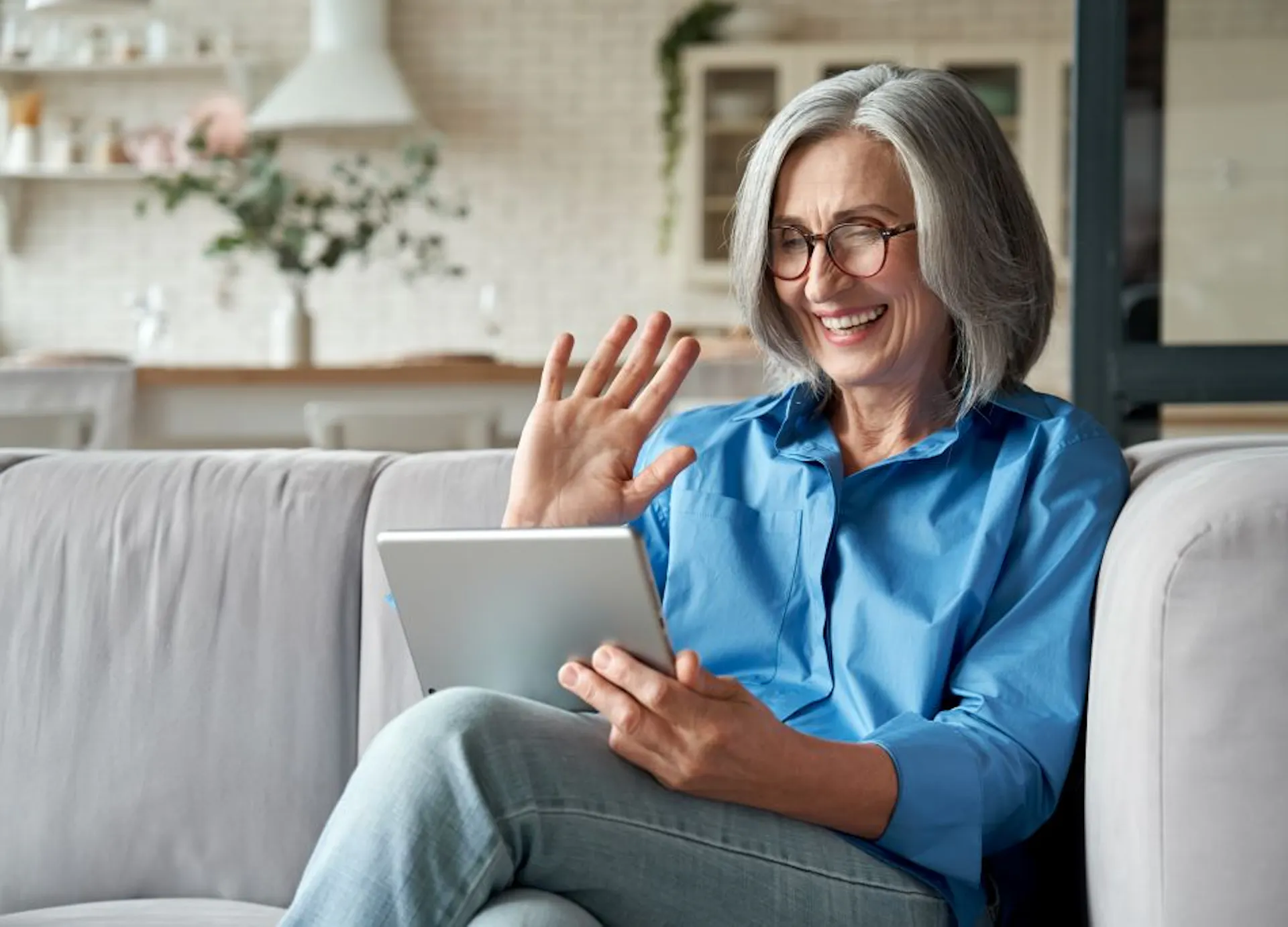 Happy 60s older mature middle aged adult woman having a telehealth appointment. 