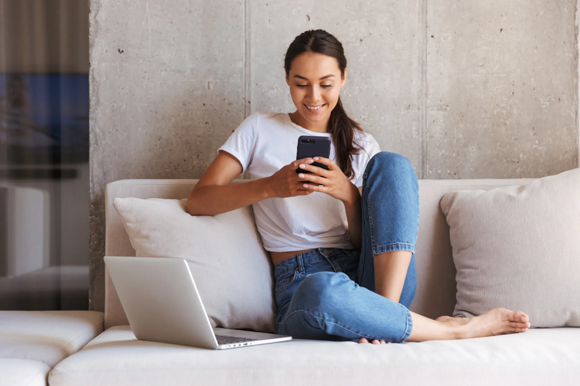 Woman on phone and using laptop