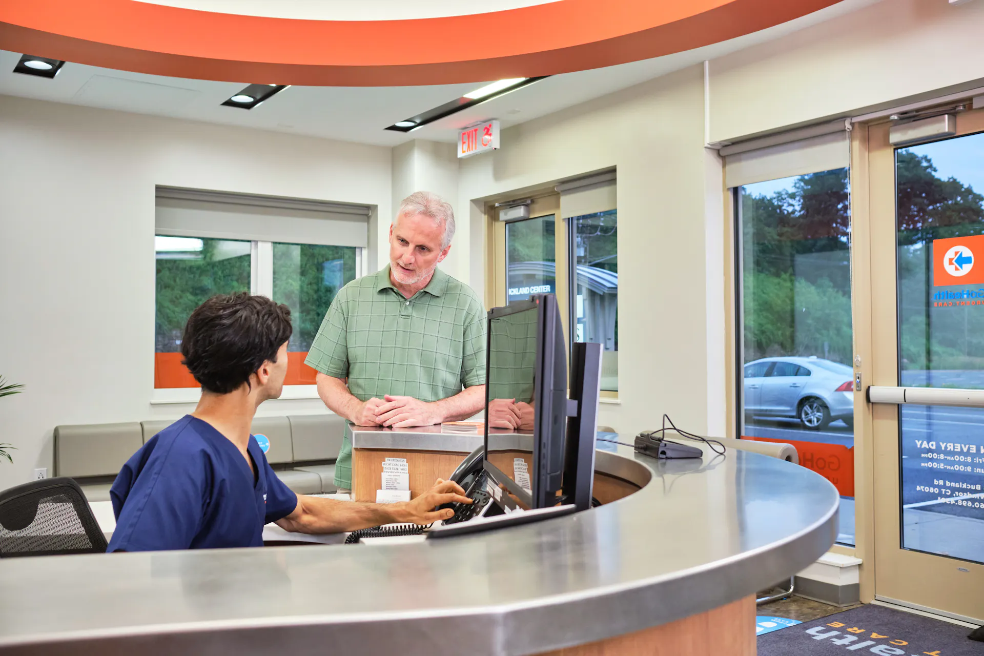 Elderly man speaking to a GoHealth receptionist