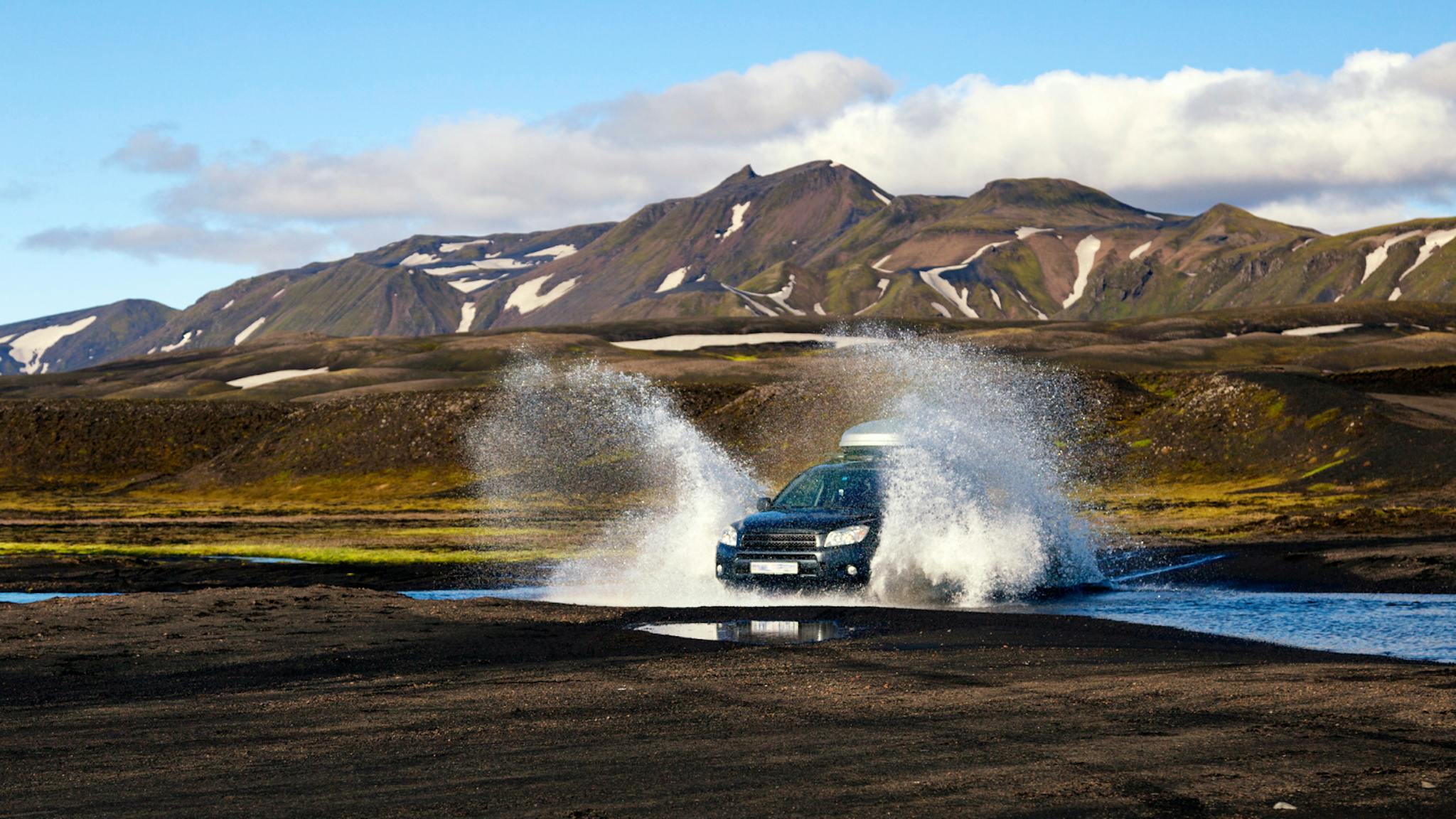 4x4 driving through a river in Iceland.