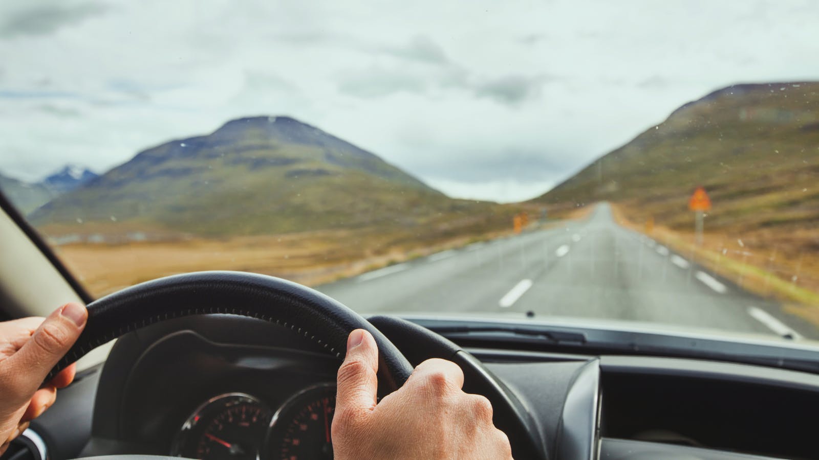 Travel to Iceland, driving a car on a beautiful scenic road.