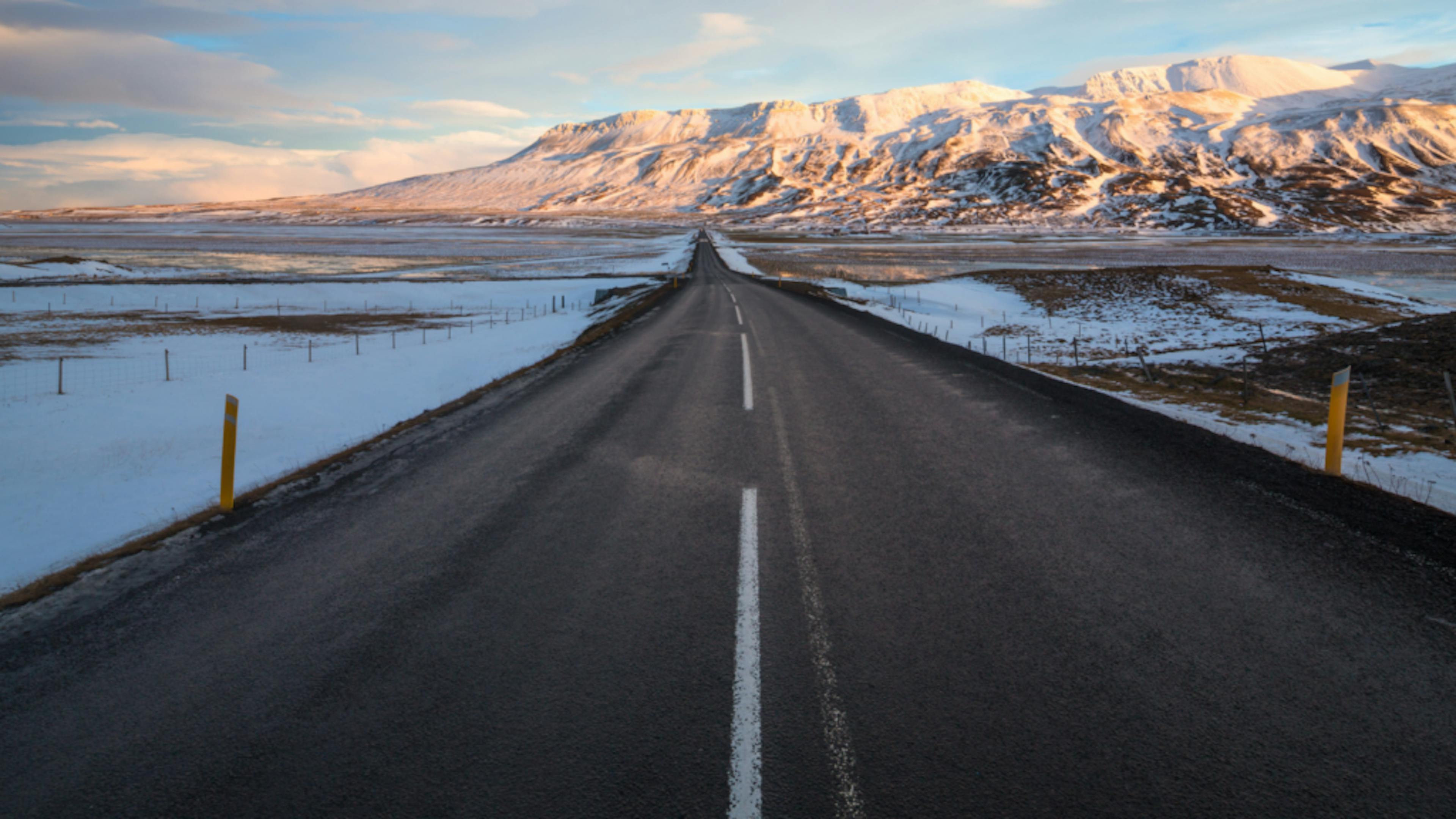 Tarmac of the Ring Road with snow-covered landscape beyond.