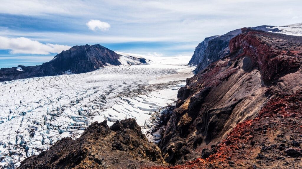 The rocky landscape of the Kverkfjöll volcano in Iceland, partially covered in snow.