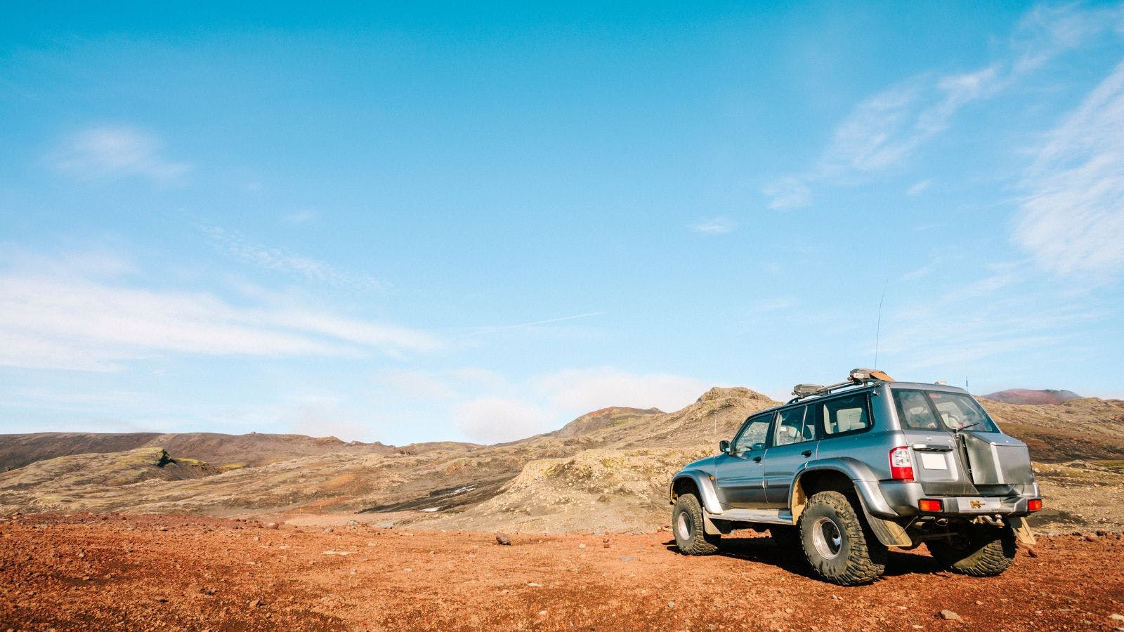 A 4x4 vehicle parked near Skogafoss, Iceland