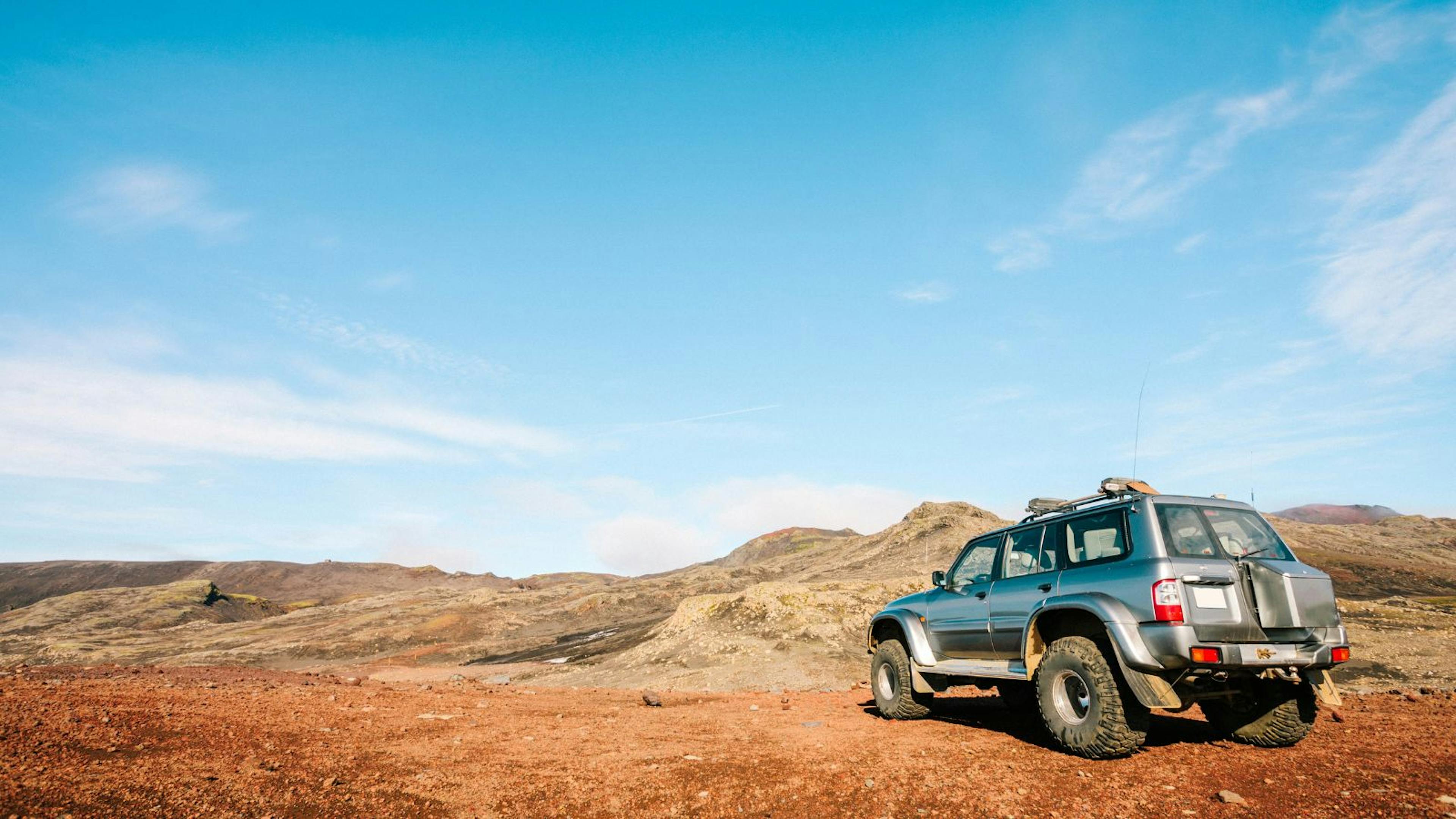 A 4x4 vehicle parked near Skogafoss, Iceland