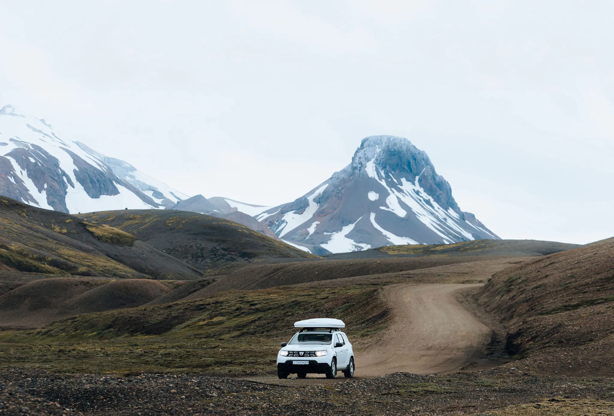 Suv driving on a gravel road in Iceland