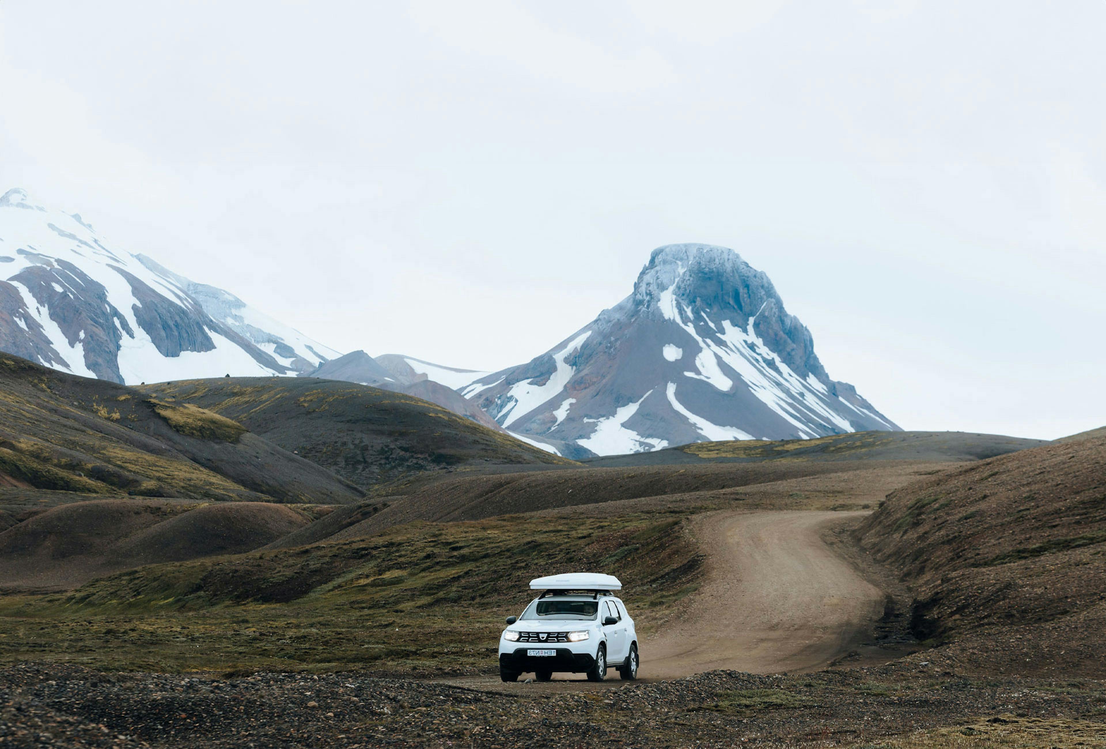 Suv driving on a gravel road in Iceland