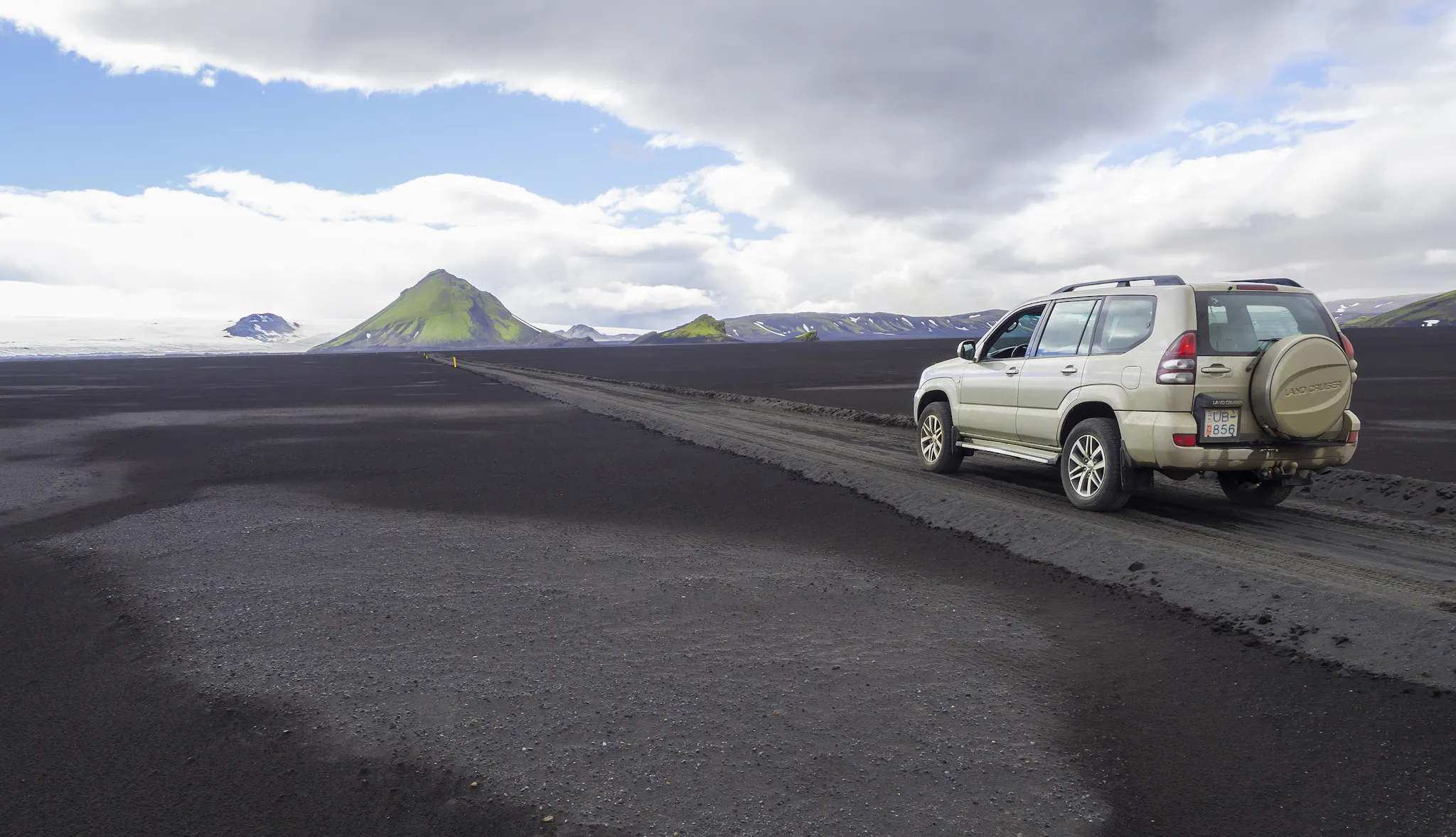 Toyota Land Cruiser on a gravel road heading towards Fjallabak Nature Reserve in Iceland.