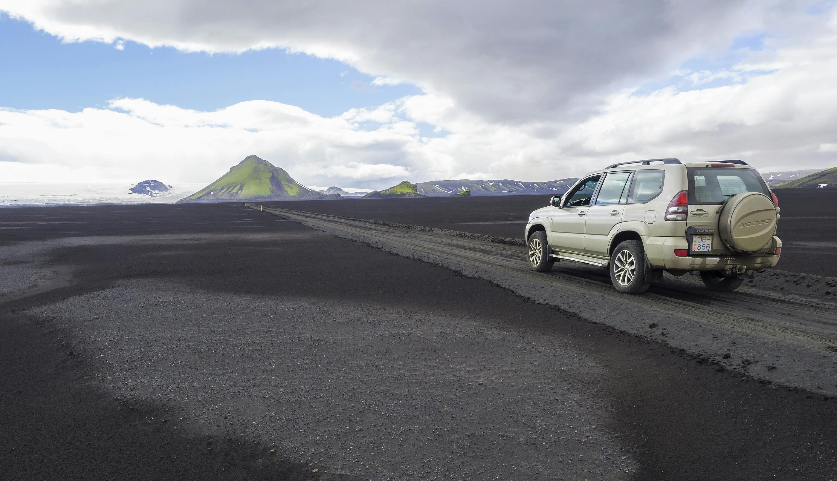 Toyota Land Cruiser on a gravel road heading towards Fjallabak Nature Reserve in Iceland.
