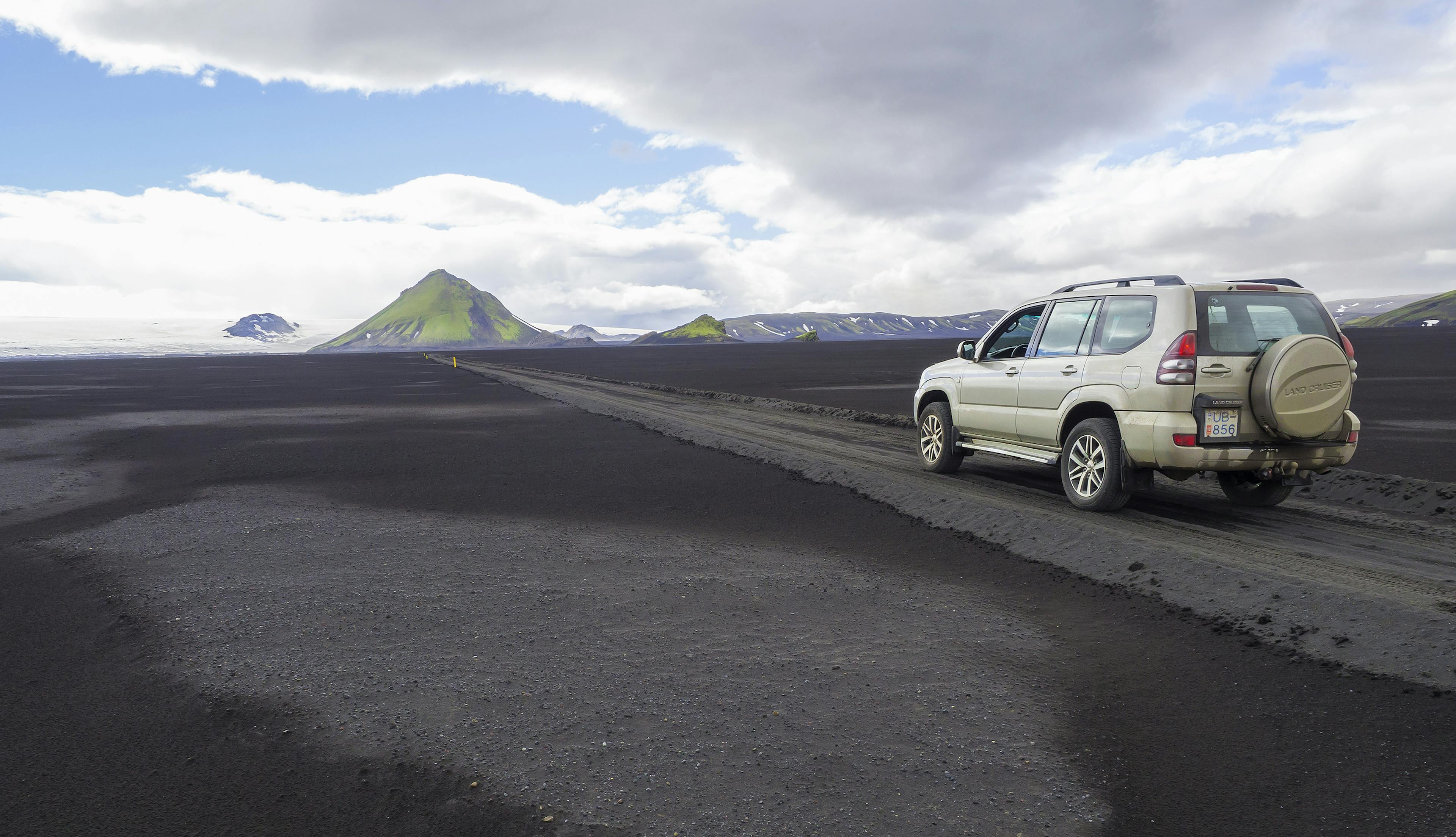 Toyota Land Cruiser on a gravel road heading towards Fjallabak Nature Reserve in Iceland.