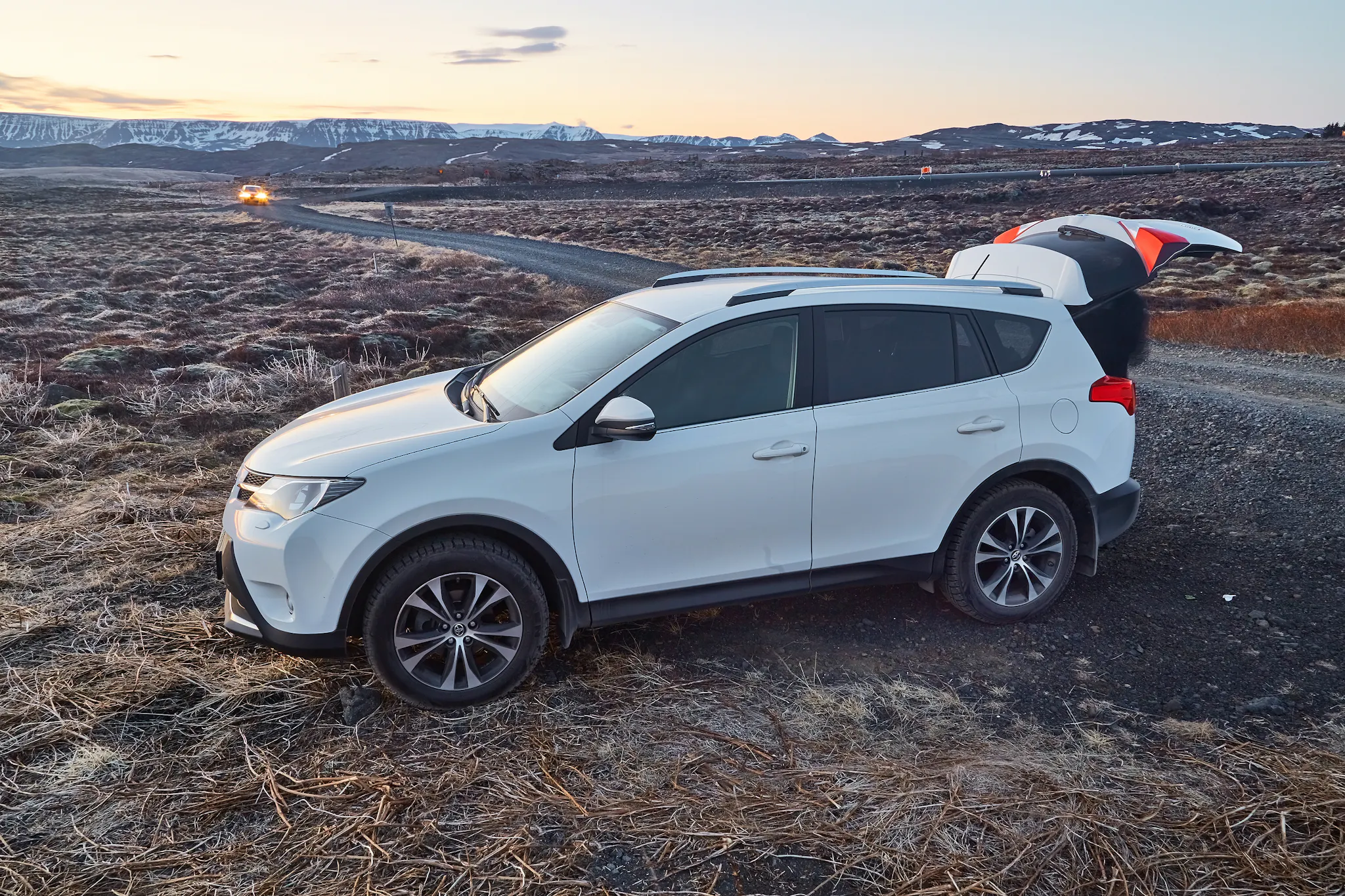 Toyota Rav4 parked on the side of a gravel road in Iceland.