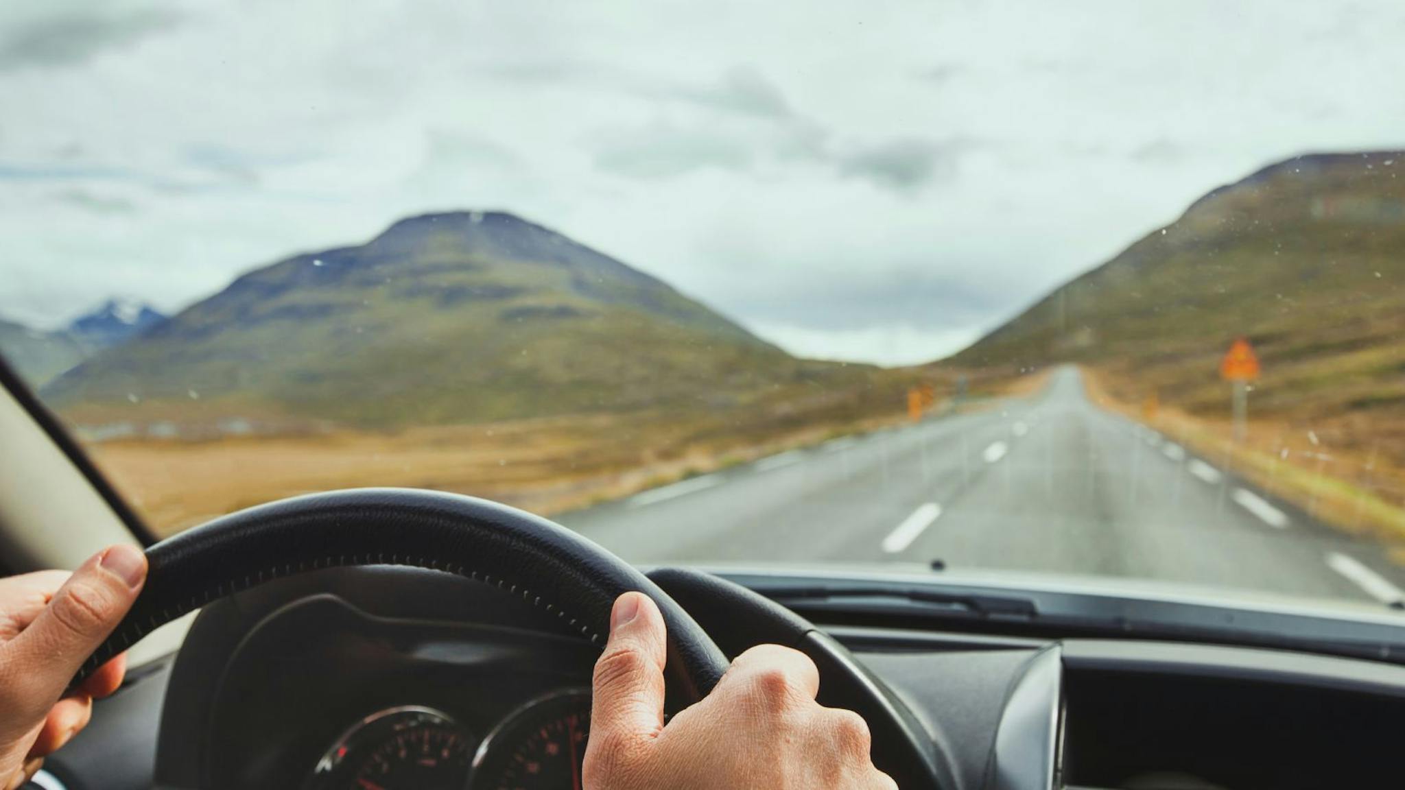 View out the windscreen of someone driving a car in Iceland.