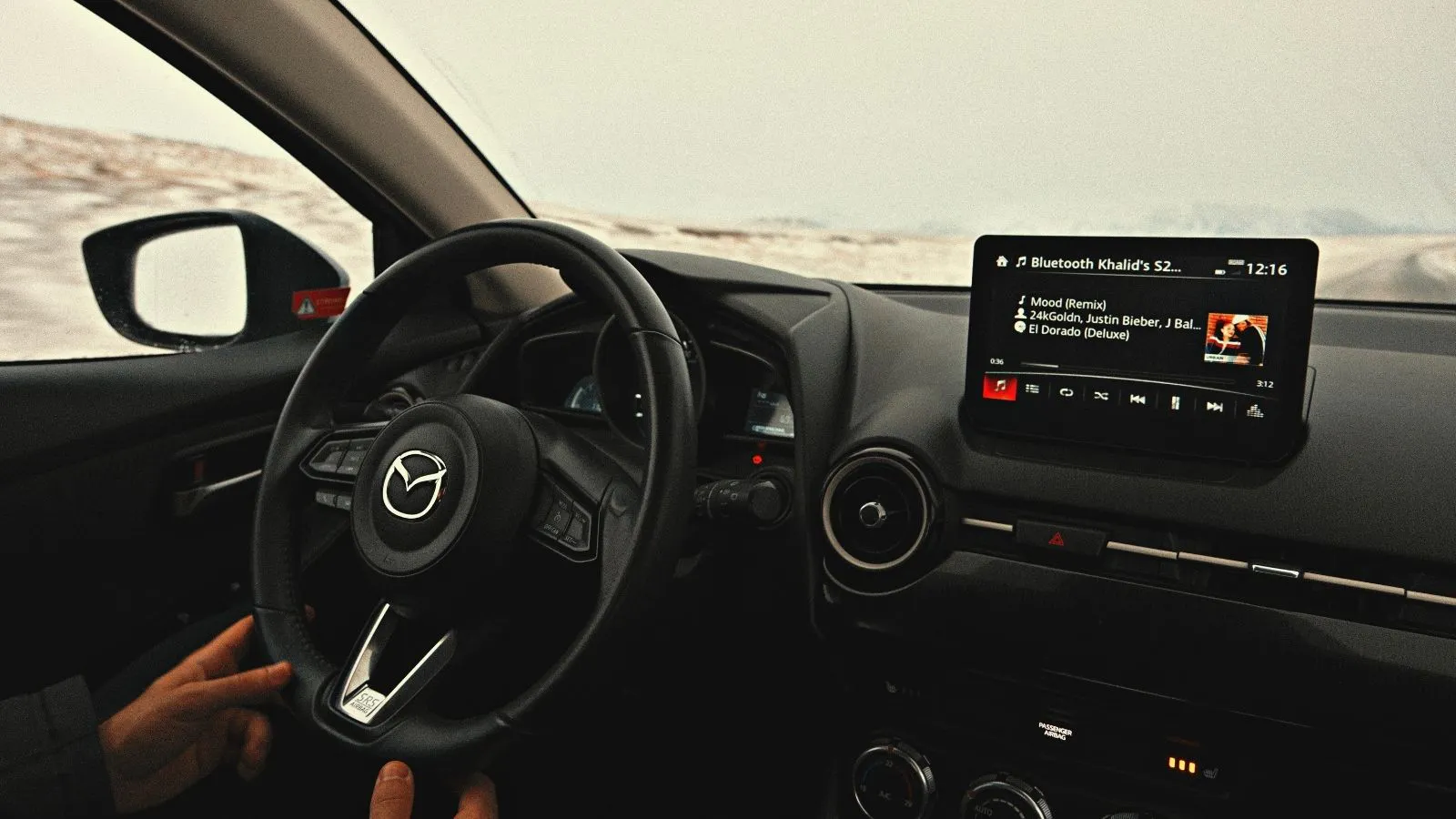 Interior of a Mazda on a winter road in Iceland.