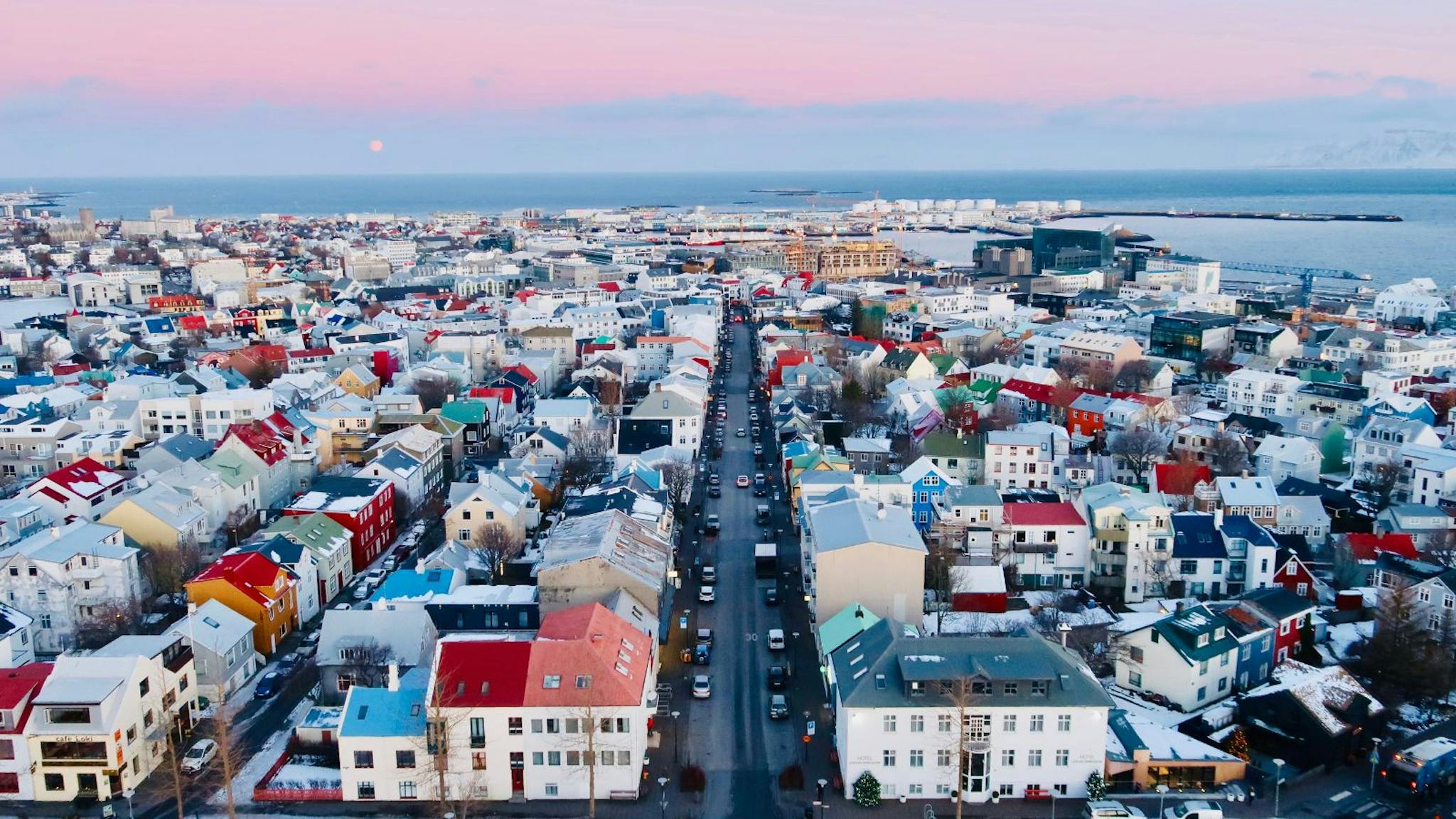 Aerial view of a main road through Reykjavík during the winter at sunset.