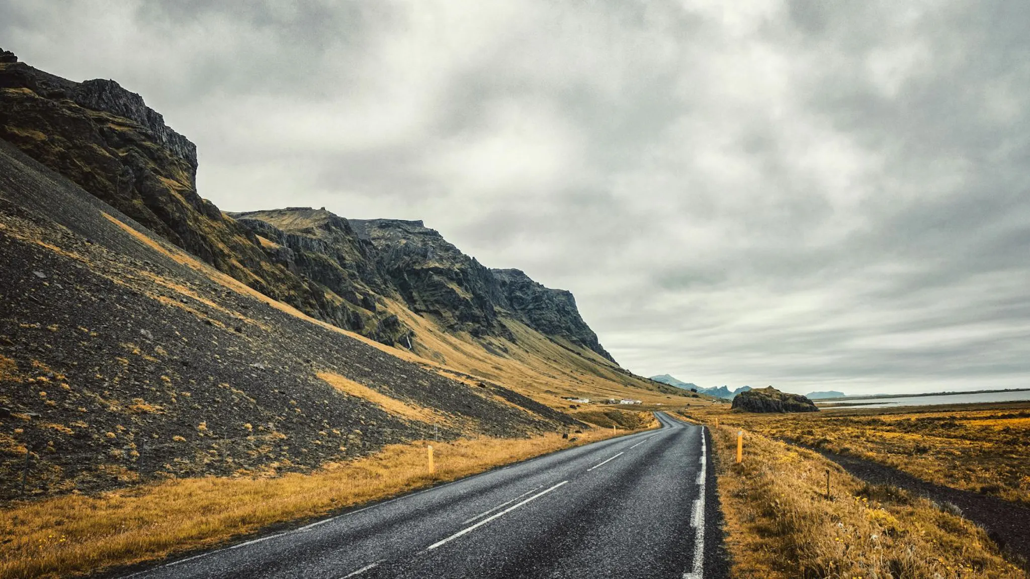 Open Icelandic road on a cloudy day.