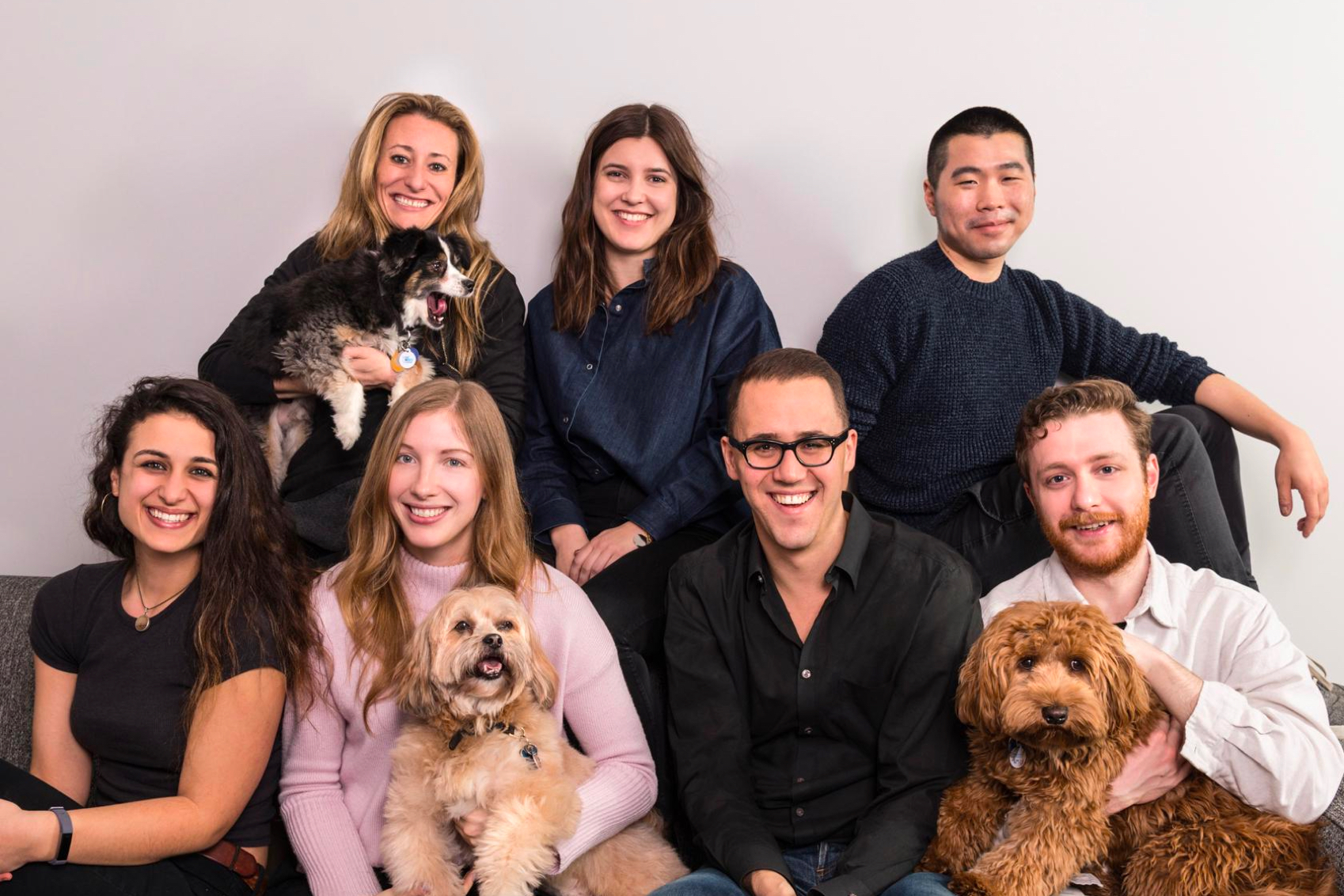 Good Dog team members team photo with three dogs.