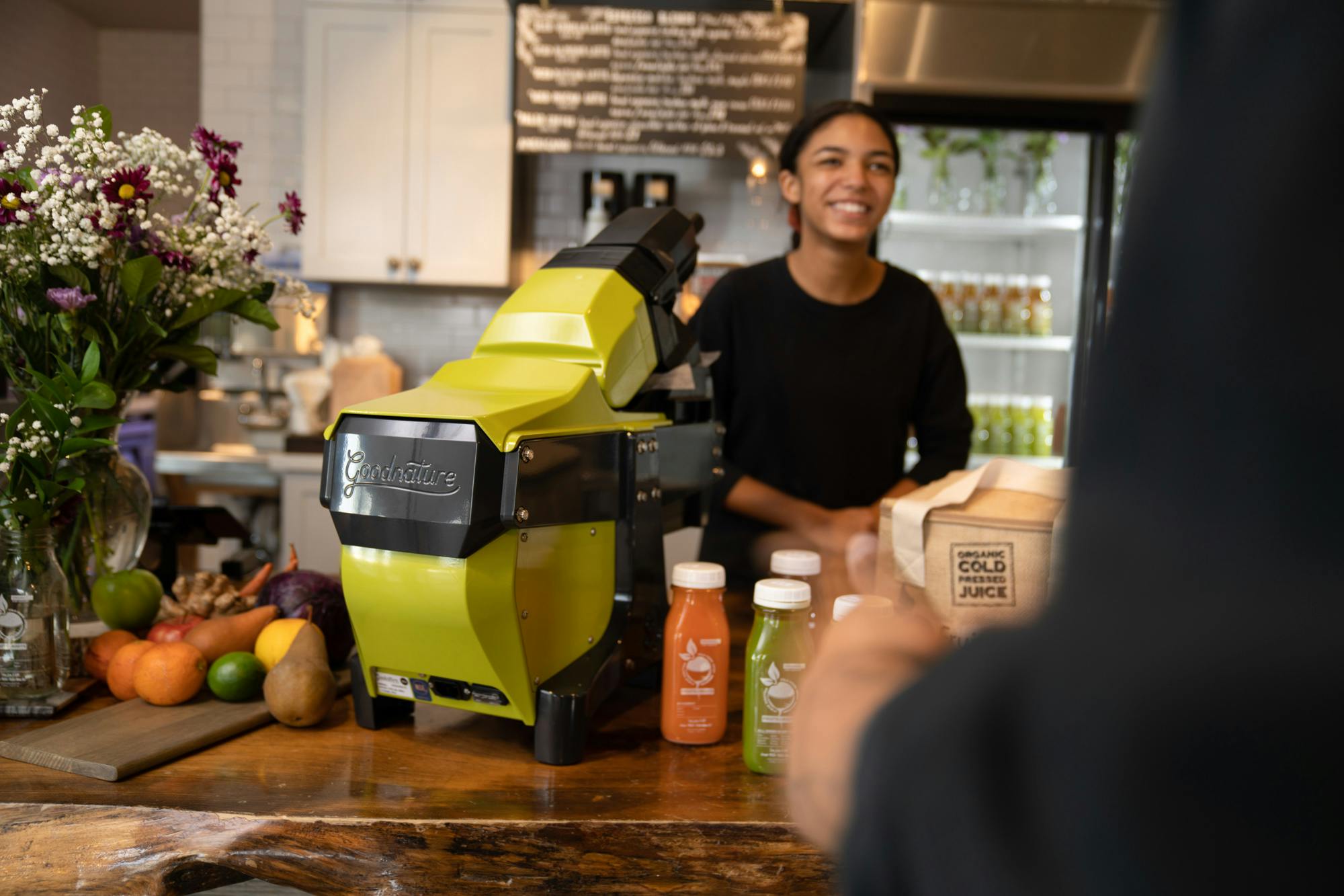 Goodnature M-1 Commercial cold press juicer on a counter in a juice bar