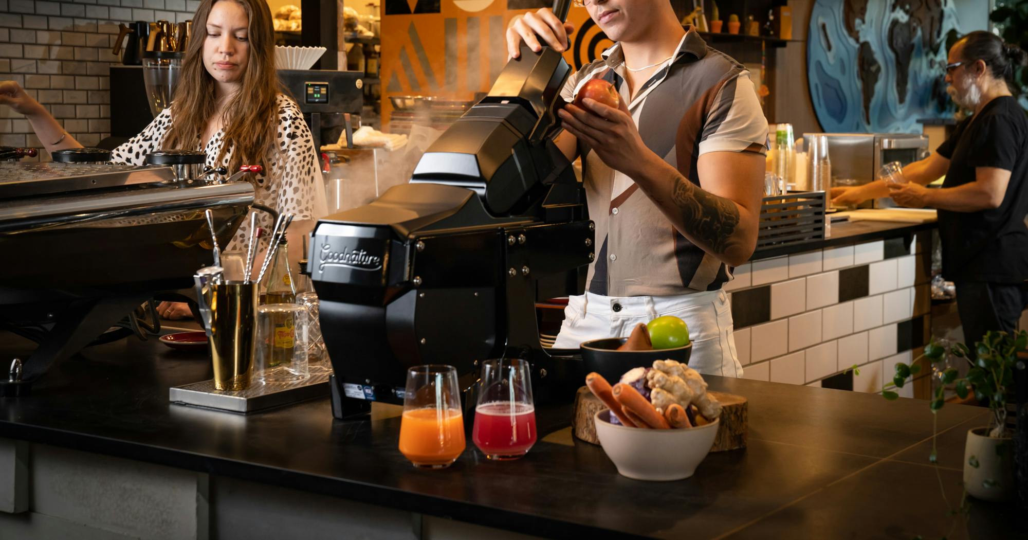 Goodnature M-1 commercial cold press juicer in a cafe coffee shop