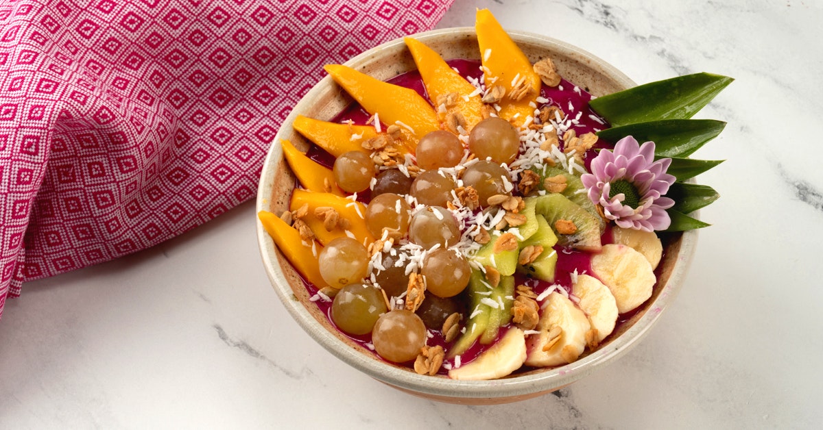 Pitaya dragonfruit smoothie bowl on a marble countertop