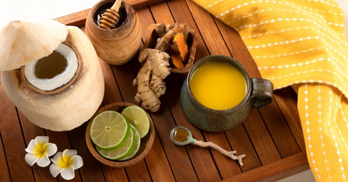 jamu juice ginger turmeric drink serving on a table with ingredients