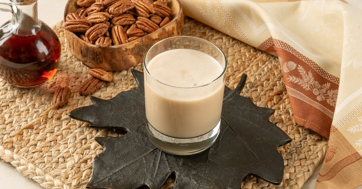 a glass of maple pecan pie milk on a thanksgiving table