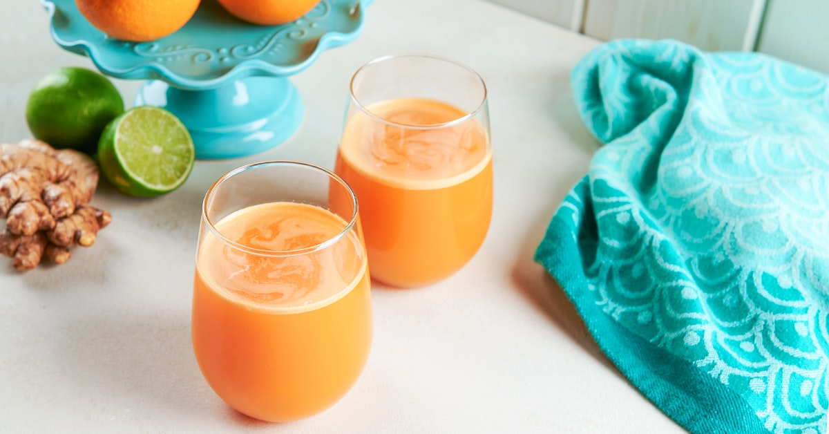 vitamin c juice recipe on a white table with ginger