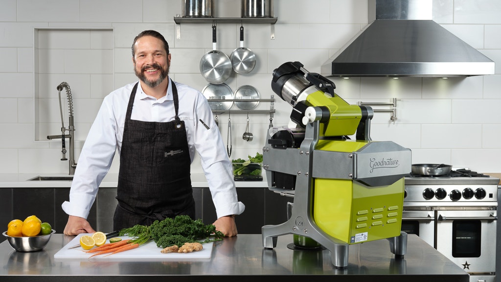 how does a juicer work? chef in front of a cold press juice machine