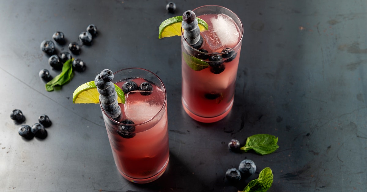 cold pressed cocktail blueberry mojito on a steel surface