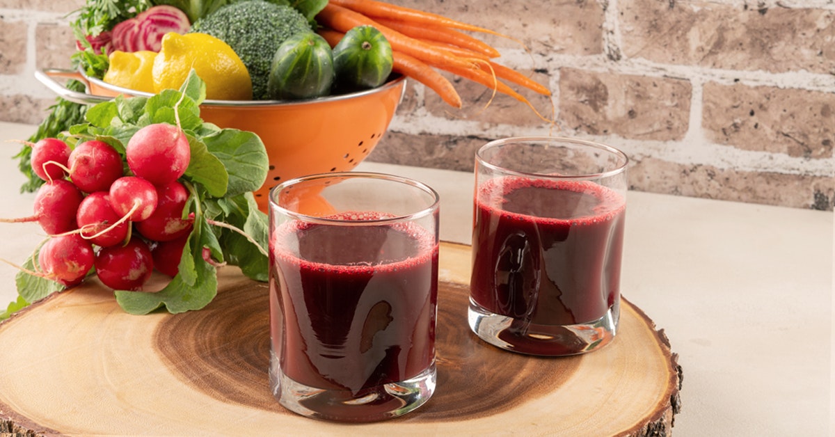 two glasses of broccoli carrot juice recipe with cucumber, beet, radishes and lemon