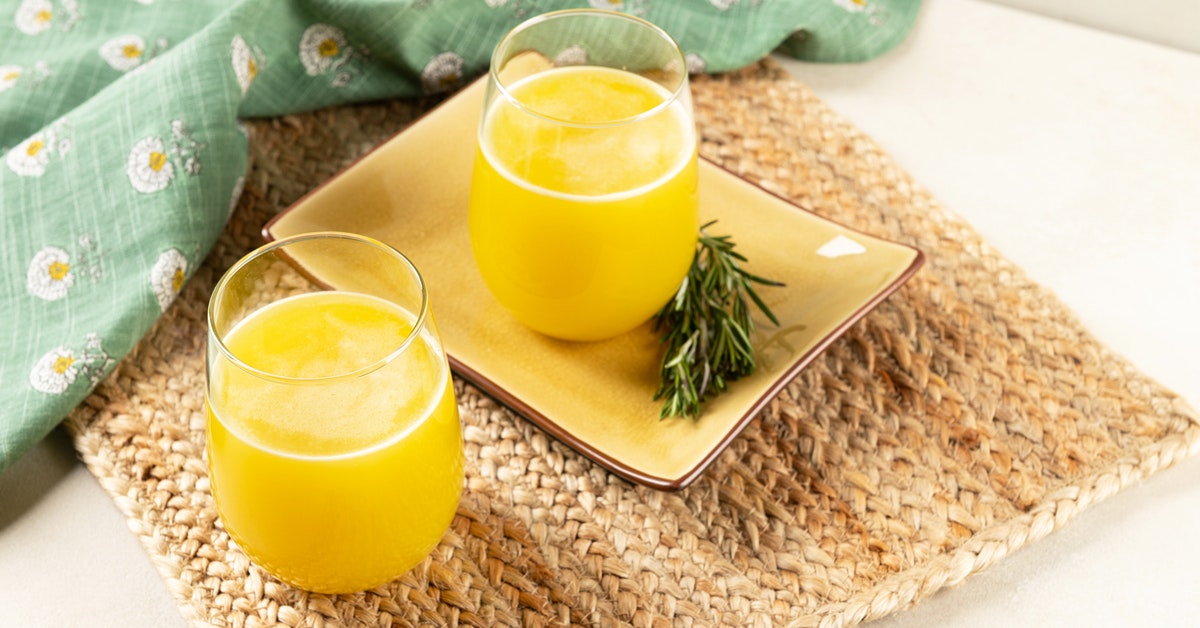 two glasses of rosemary citrus lemonade on a table