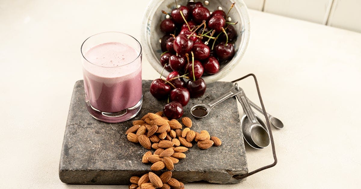 homemade cherry vanilla almond milk on a stone cutting board