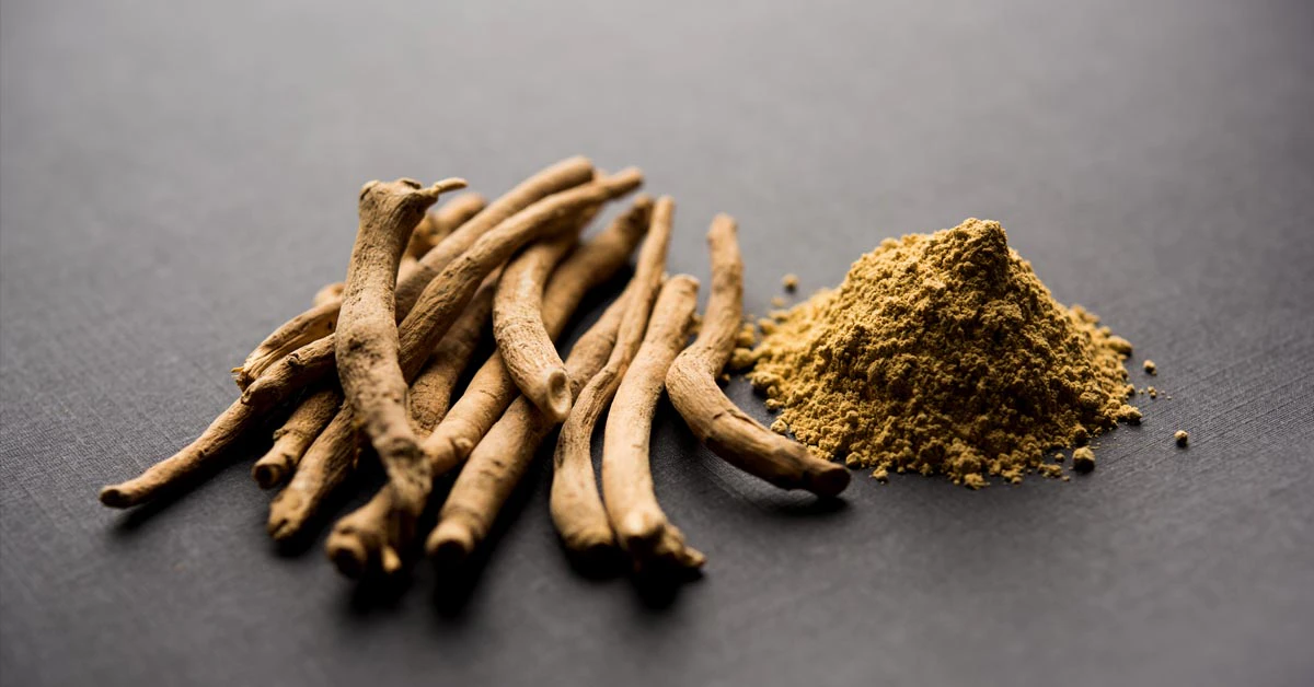 ashwagandha root and powder on a black table