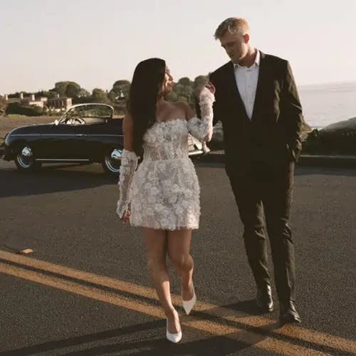 Bride and groom walking across the street.